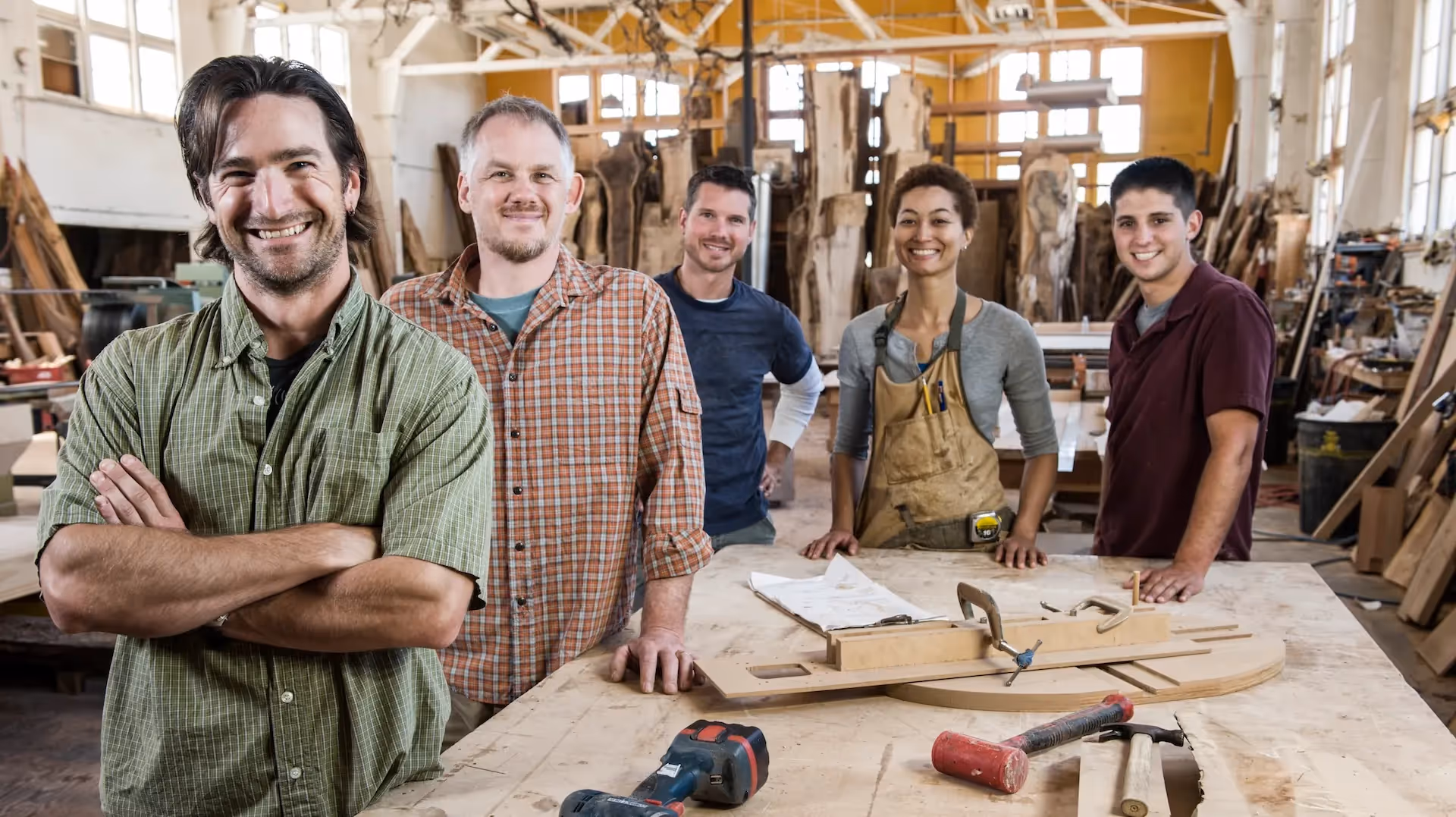 Multi-racial factory workers standing together — Protecting Employees