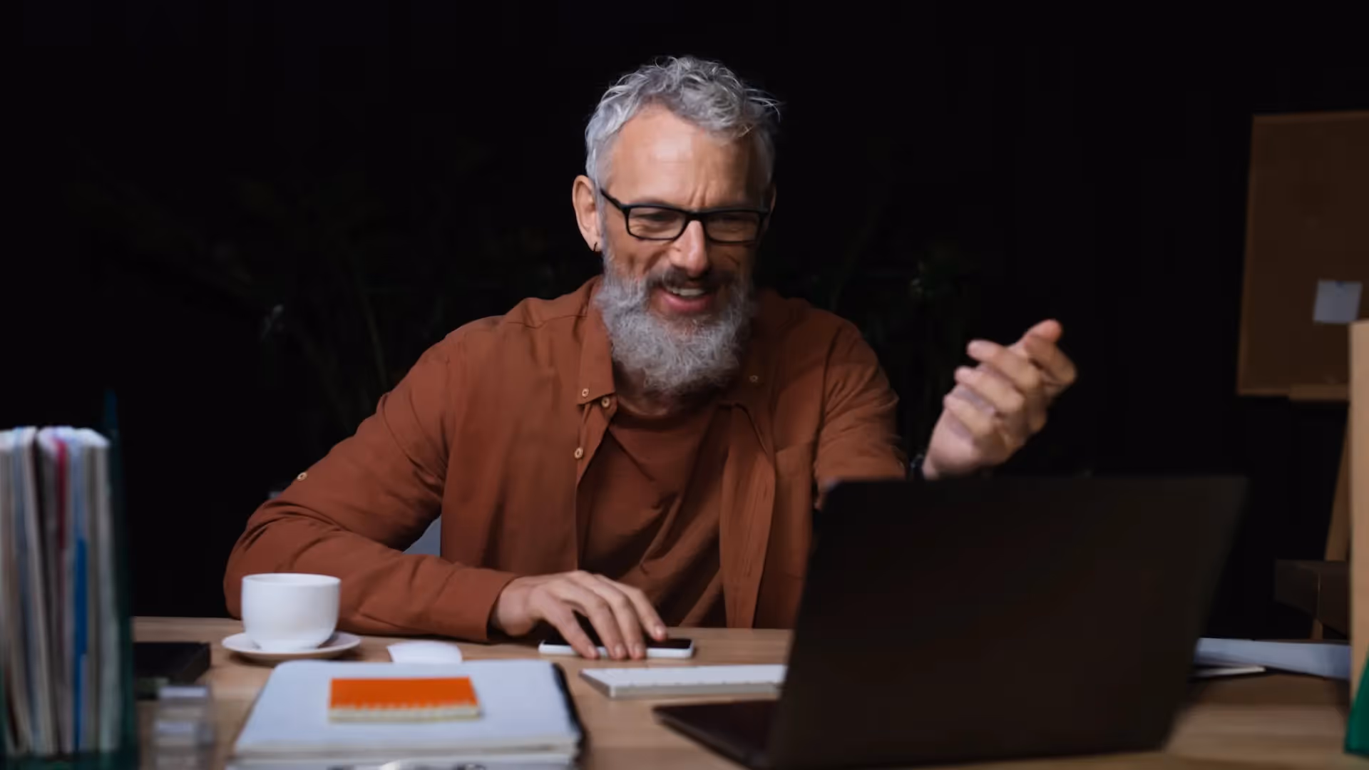 Happy grey-haired businessman on video call — Sale-Ready Before Retirement