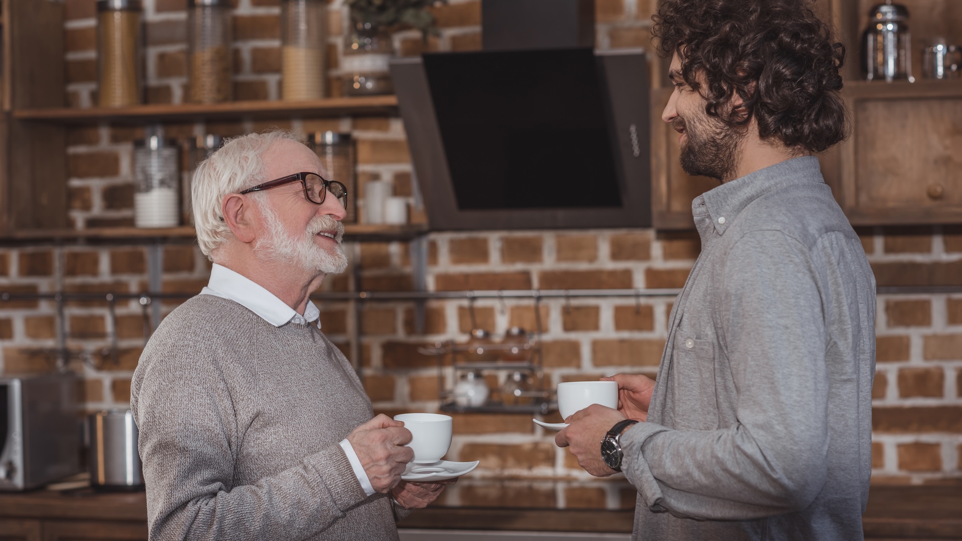 Image of older business owner talking to younger buyer of his business