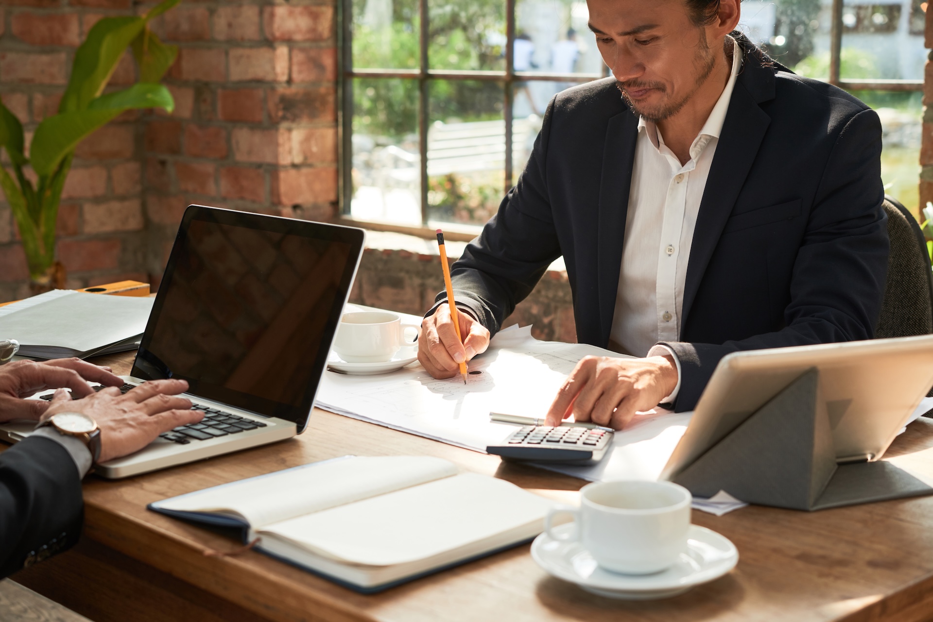 Image of two businessmen working through company accounts