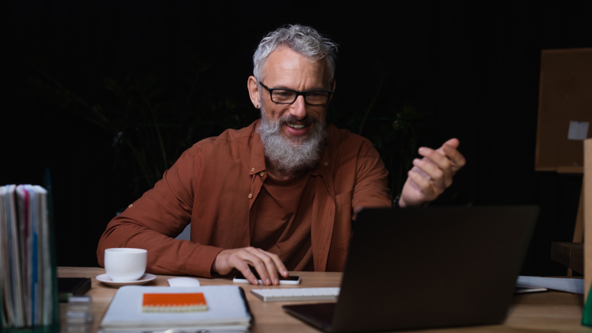 Image of older man preparing documents to sell his business before retirement